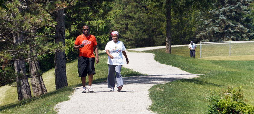 Two people walking at Catalpa Oaks