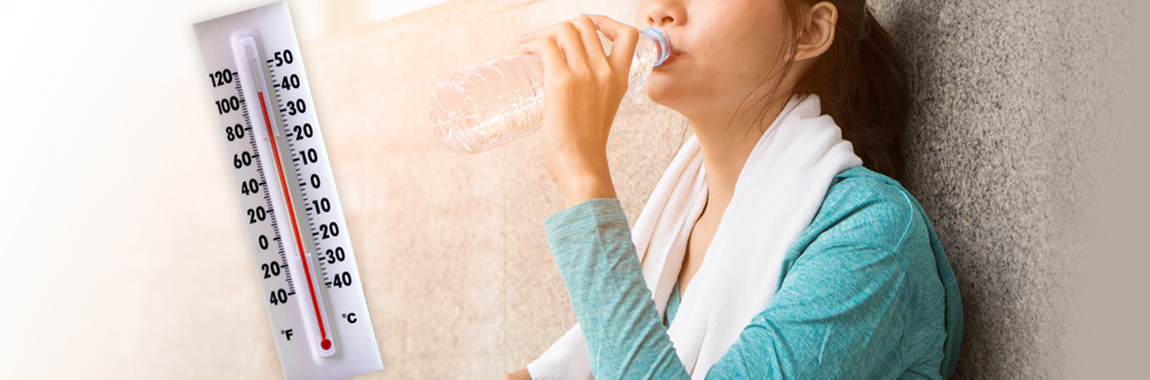 Heat safety, woman drinking water