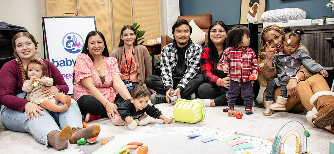 Adults and toddlers gather at a baby playgroup with toys.