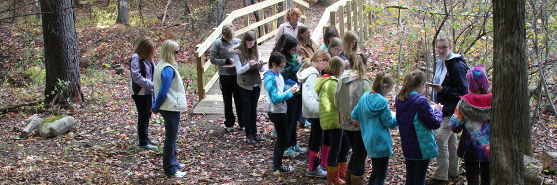 Student group with guide on Wint Nature Trail in the fall.