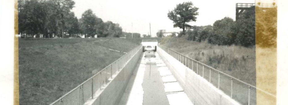 Historic photo of drainage channel running through a field